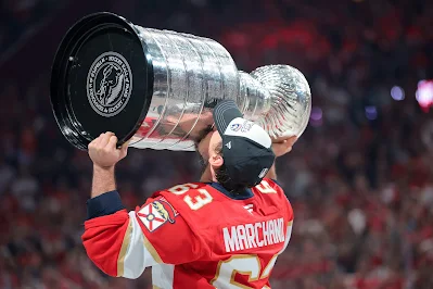 Florida Panthers forward Brad Marchand kisses the cup after winning it in 2025.